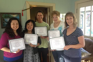 A group of people standing with certificates